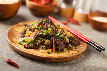 Traditional Korean Bulgogi dish.  Thinly cut, grilled beef, served with rice and vegetables.