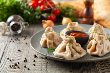 Traditional Georgian dumplings with meat. Khinkali. Served on a plate with traditional Georgian bread.