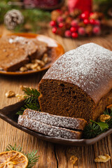Homemade gingerbread cake. Christmas decoration. Front view. Natural wooden background.