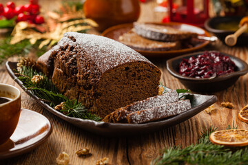 Homemade gingerbread cake. Christmas decoration. Front view. Natural wooden background.