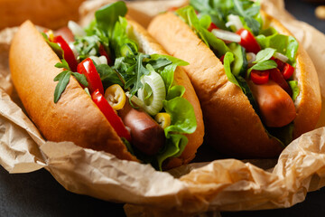 Vegetarian hot dogs with soy sausages and fresh vegetables. Front view.