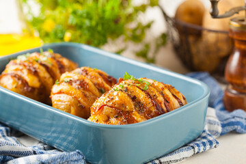 Baked potatoes in Swedish. Hasselback. Stuffed with cheese and bacon. Top view.