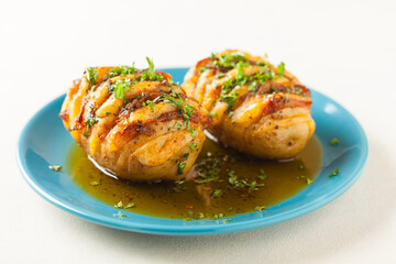Baked potatoes in Swedish. Hasselback. Stuffed with cheese and bacon. Top view.