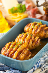 Baked potatoes in Swedish. Hasselback. Stuffed with cheese and bacon. Top view.