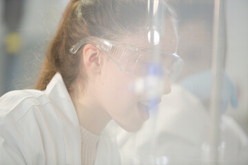 Girl student conducting science experiment in classroom laboratory
