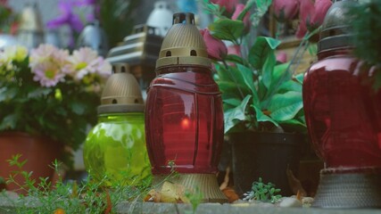 Flowers and Glass Lantern Candles and Cemetery Columbarium Funeral Urn Wall Before All Saints Day	
