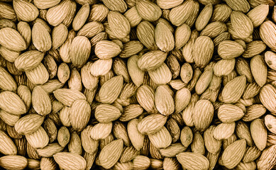 background peeled large almonds dark brown close-up