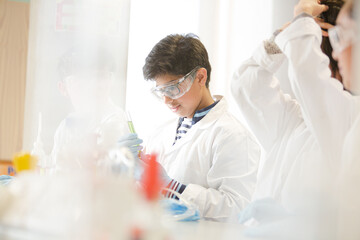 Students conducting scientific experiment in laboratory classroom