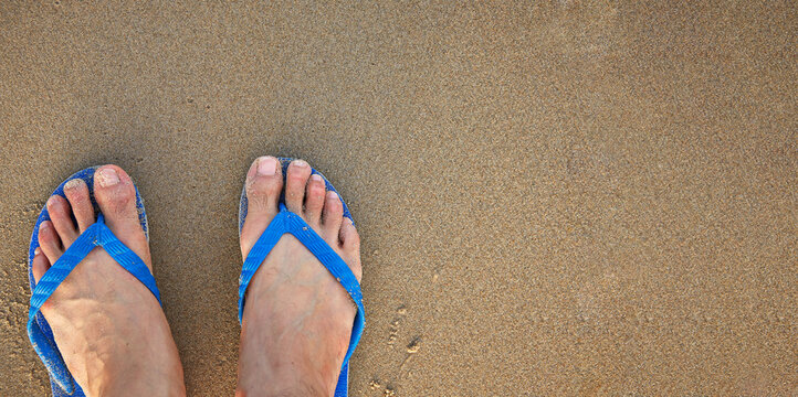 feet on the beach, flip flops
