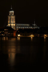 Fototapeta na wymiar The Great Church in the City of Deventer, the Netherlands, at night with reflection in the water