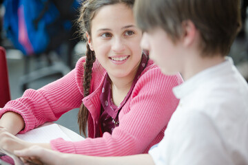Students using digital tablet in library