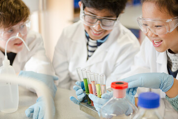 Students conducting scientific experiment in laboratory classroom