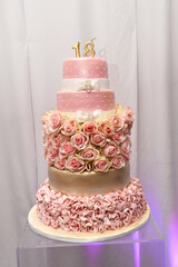 18th birthday party cake decorated with a beautiful flower arrangement around the base with a...
