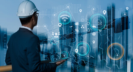 Future building construction engineering and technology project concept. double exposure graphic with engineer using digital tablet and smart industry and IOT software to control operation.
