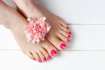 Obraz na płótnie Canvas Pink pedicure with on white wooden background top view, copy space