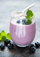 Glass of blueberry yogurt with blueberries