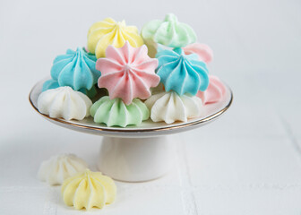 Small colorful meringues on the ceramic  stand