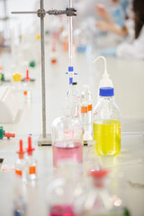 Liquid in bottles, test tubes and beakers in science laboratory classroom