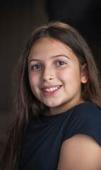 Beauty low-key portrait of a beautiful smiling school girl