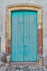 Light blue painted antique wooden door facade with copy space
