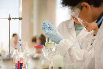 Students conducting scientific experiment in laboratory classroom