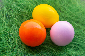 painted eggs decor easter pink, orange on green grass background