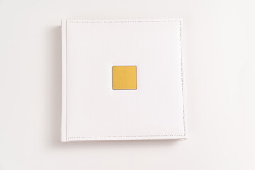 white book in leather binding with a gold metal insert for inscription. printing products....