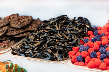 assorted sweets liquorice strips, jelly candies and chocolate focus in the center