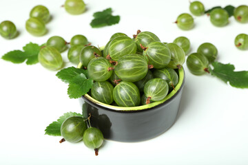 Bowl of ripe gooseberry on white background