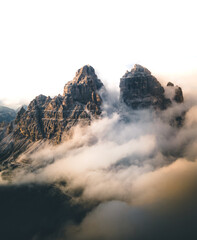 Aerial moody landscape of Tre Cime di lavaredo mountains in cloudy day, Dolomites, Alps, South Tyrol, Italy.