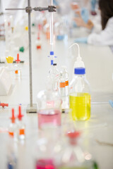 Liquid in bottles, test tubes and beakers in science laboratory classroom