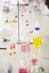 Liquid in bottles, test tubes and beakers in science laboratory classroom