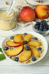 Concept of healthy food with peach yogurt on white wooden table