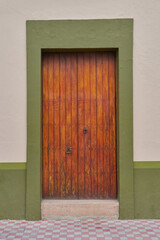 Antique dry green painted wood door facade with copy space