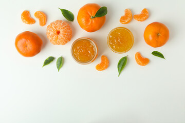 Mandarin jam and ingredients on white background, top view