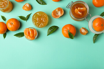 Mandarin jam and ingredients on mint background, top view