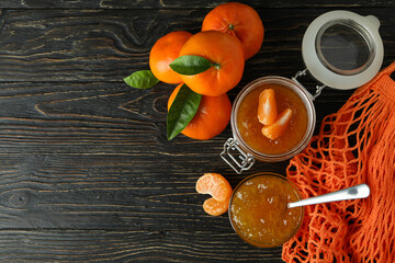 Mandarin jam and ingredients on rustic wooden background