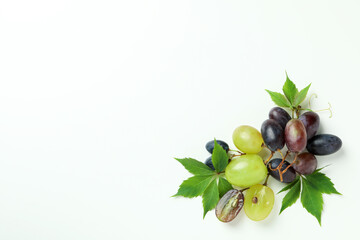 Ripe grape with leaves on white background