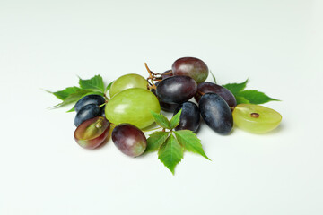 Ripe grape with leaves on white background