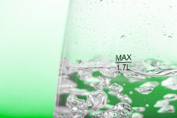A water is boiled in an electric kettle with transparent walls, close up.