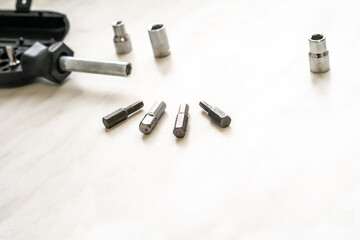 screwdriver with replaceable bits, Phillips, slotted on a wooden background