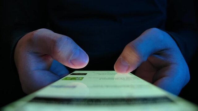 Young Man Watching and Read News on Smart Phone Close-up. Casual Male Browse Web Page or App on Magazine Portal. Look Financial or Economy Journal in Hold Hand Phone. Read Publication Document on Site