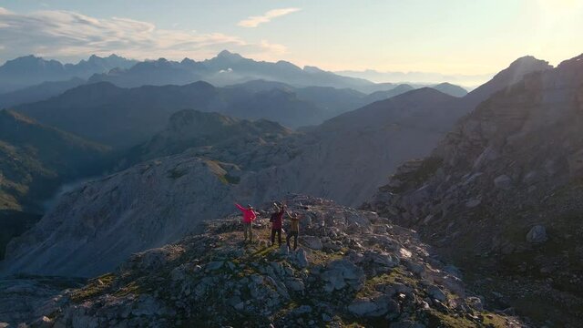 Happy hikers high in the mountains. Aerial footage