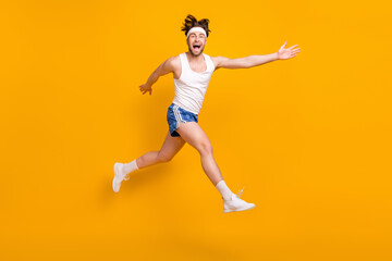 Full length body size view of attractive cheerful crazy guy jumping running having fun isolated...