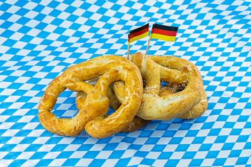 fresh pretzels on white, blue background oktoberfest symbol