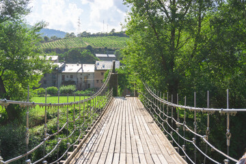 Suspension bridge made of wood and steel ropes over the Noguera Pallaresa river