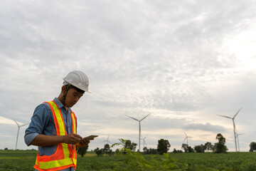 Fototapeta na wymiar Picture of asian male electrical engineer working at wind turbine power generator station