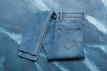 Light jeans on a blue background.