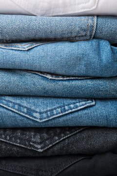 A stack of different types of jeans. Jeans of different colors. Jeans texture.