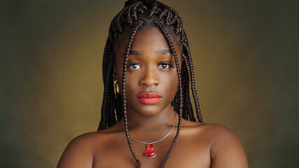 Dreads style close-up portrait of beautiful black woman. Typical African style.